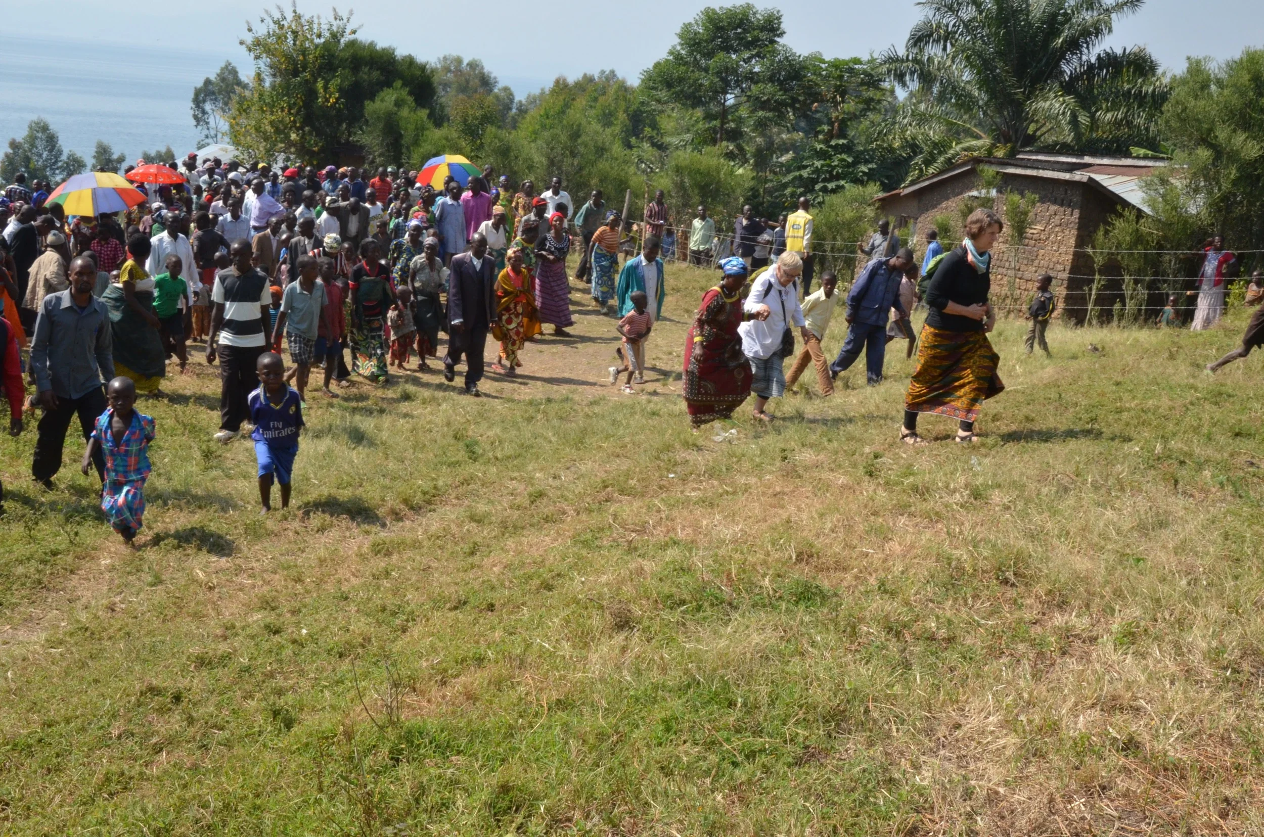 Walking with the community on the land that has been purchased for a future health center on Idjwi Island