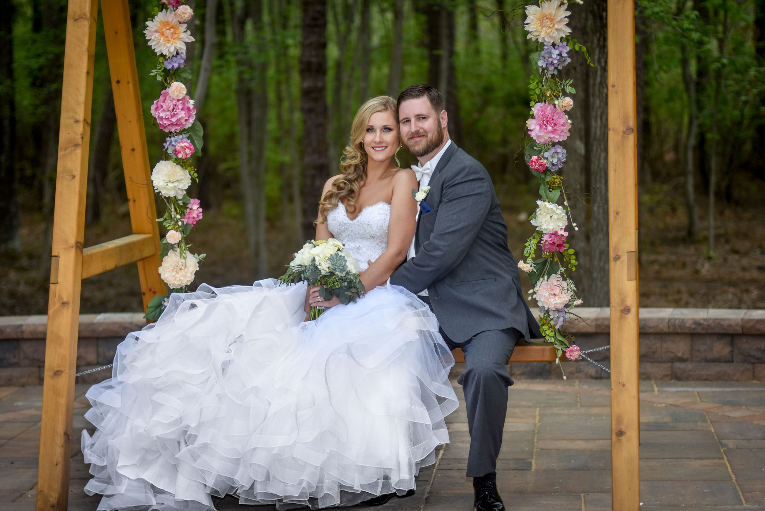 Bride and groom on flower swing at Brigalias