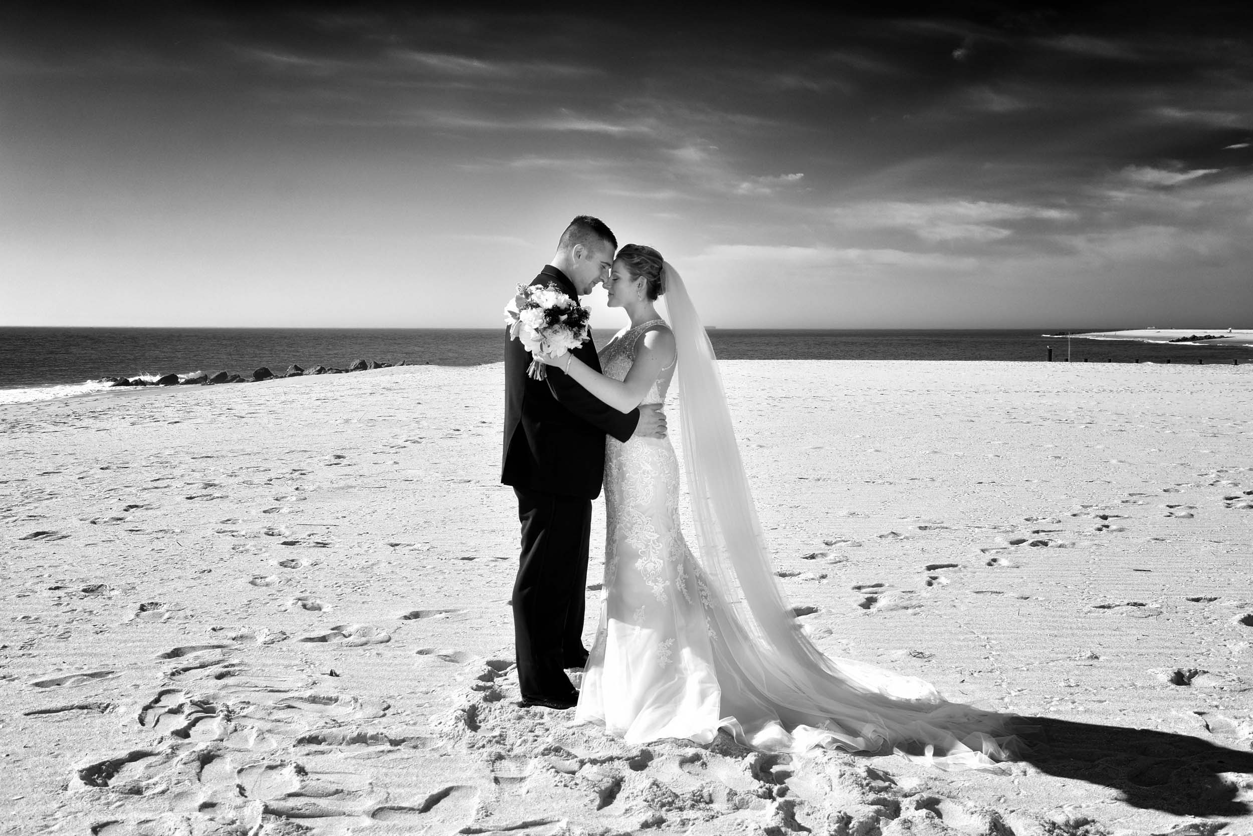 Dramatic bride and groom on beach