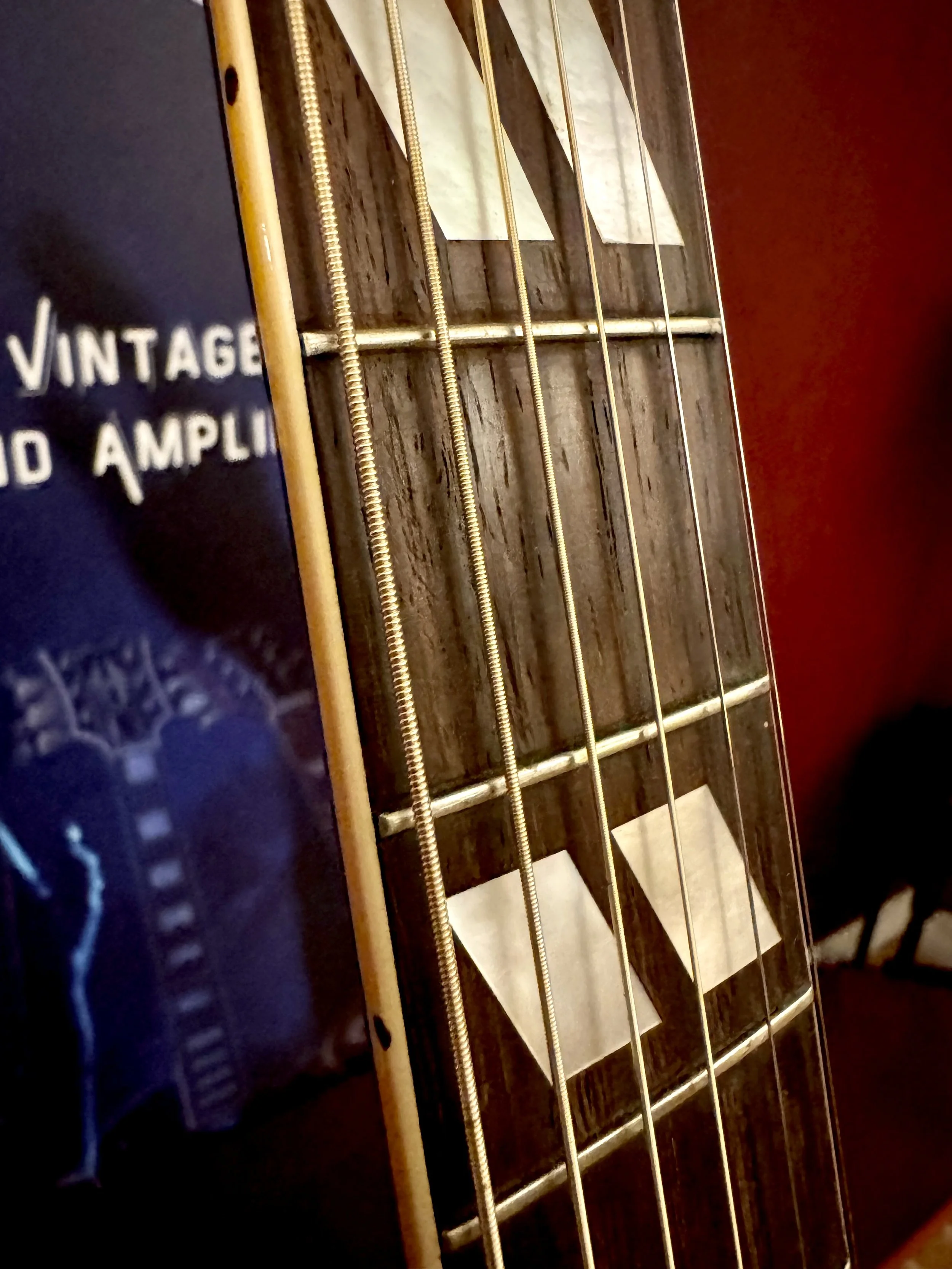Close up of the frets of a beautiful vintage 1951 Gibson L-7 acoustic guitar in rare Ebony finish, for sale at Winter Park Vintage Guitars