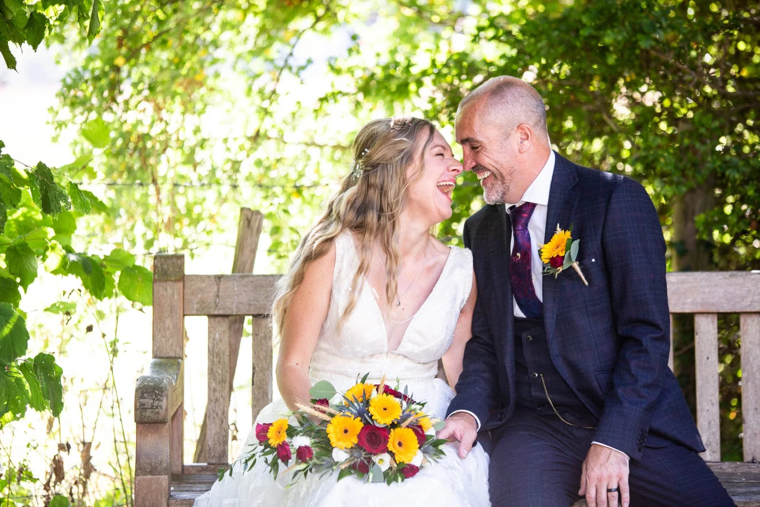 When to Start Wedding Planning bride and groom laughing on bench