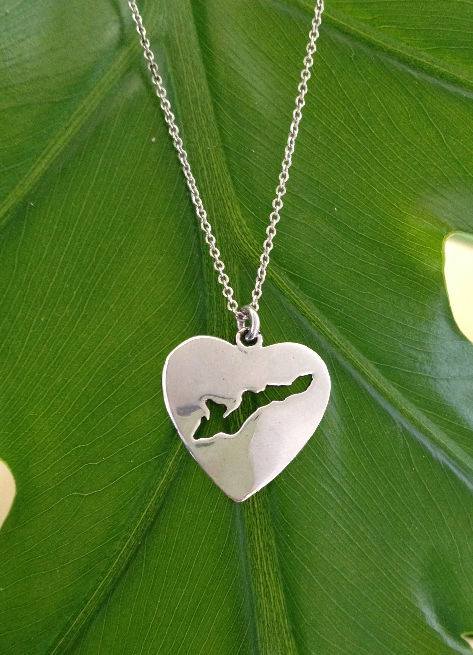 Handmade sterling silver Fishers Island heart charm on leaf