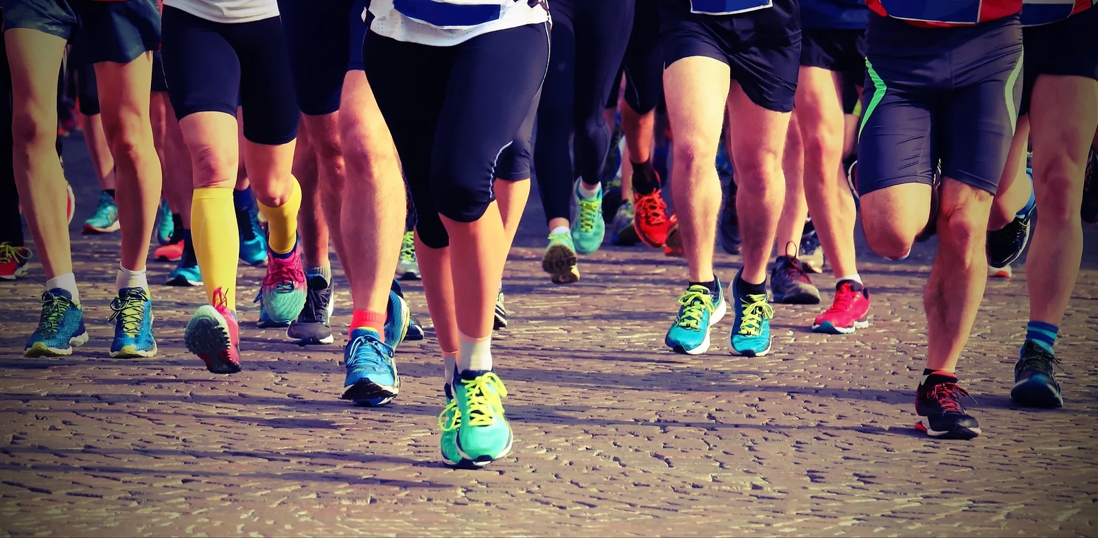 Group Of Runners On The Finish Line Of An Exciting Marathon Race