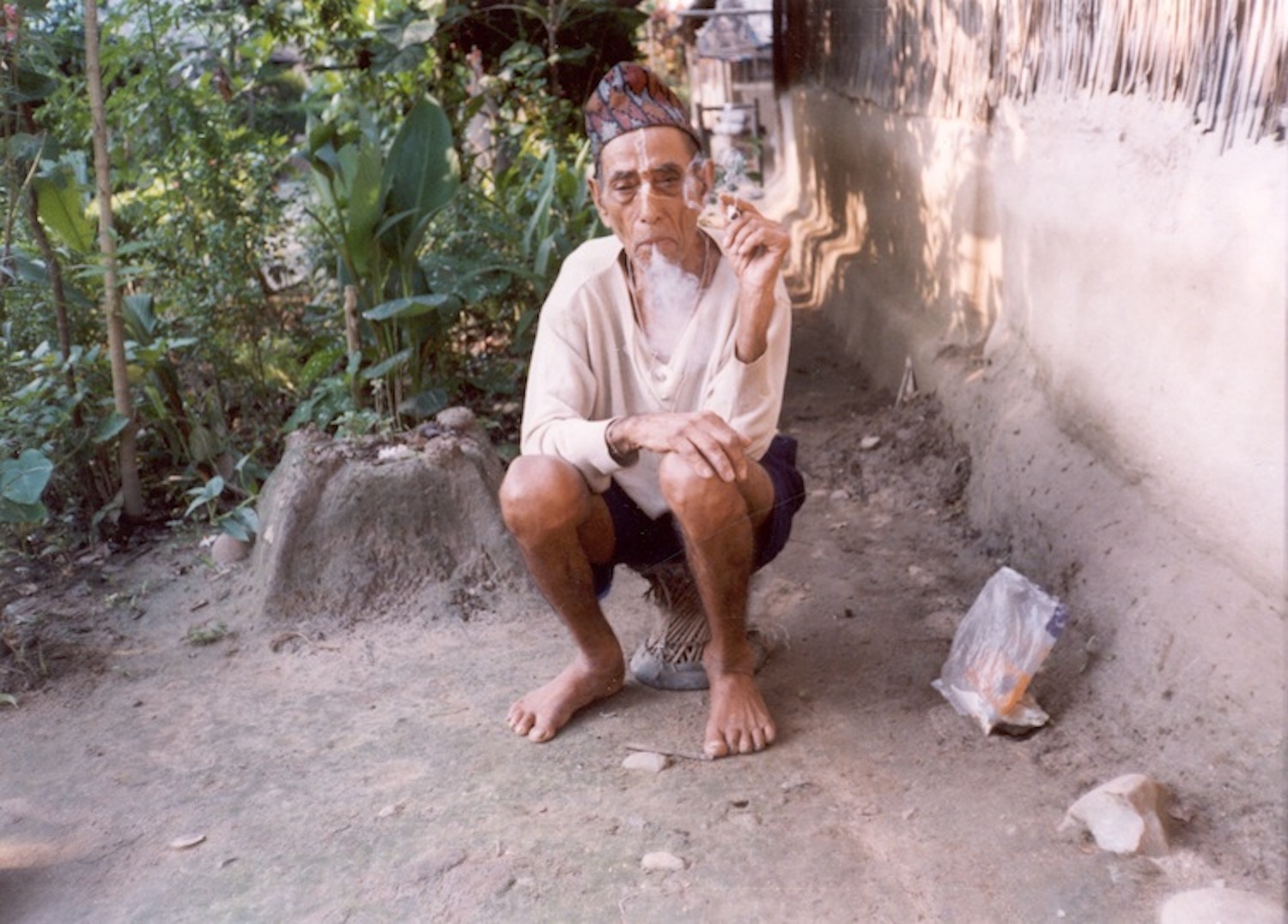 Puff of wind He is a 97 year old man who lives in the camp. He thinks life is like smoke that a puff of wind can disperse. He is a pessimist. He says in Bhutan he was very rich and that he came to Nepal with only the clothes that he was wearing. Now he is poor. His clothes, plates and pots are given by UNHCR. He complains that he will die without seeing his country again. Myself and others tell him that is not the way to think, that our problems will soon be solved. (c) Yethi Raj / Rose Class / PhotoVoice