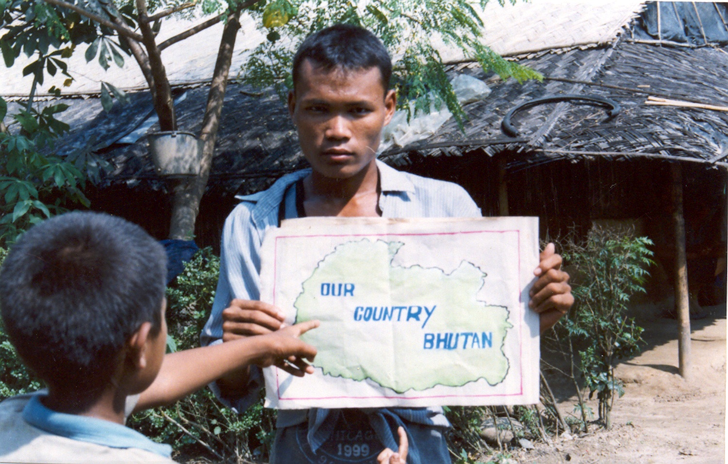 Here my brother is holding a map of our country Bhutan. Bhutan is called Druk Yuk, The Land of the Thunder Dragon. Though we are away from our country an unforgettable picture of Bhutan is printed in every Bhutanese heart. We felt very sad to leave Bhutan behind but our parents had to leave to survive. (c) Nar Bdr / Rose Class / PhotoVoice
