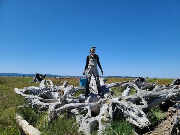 Aileen Arata stands on driftwood at Port Susan Bay Preserve for a day of restoration work.