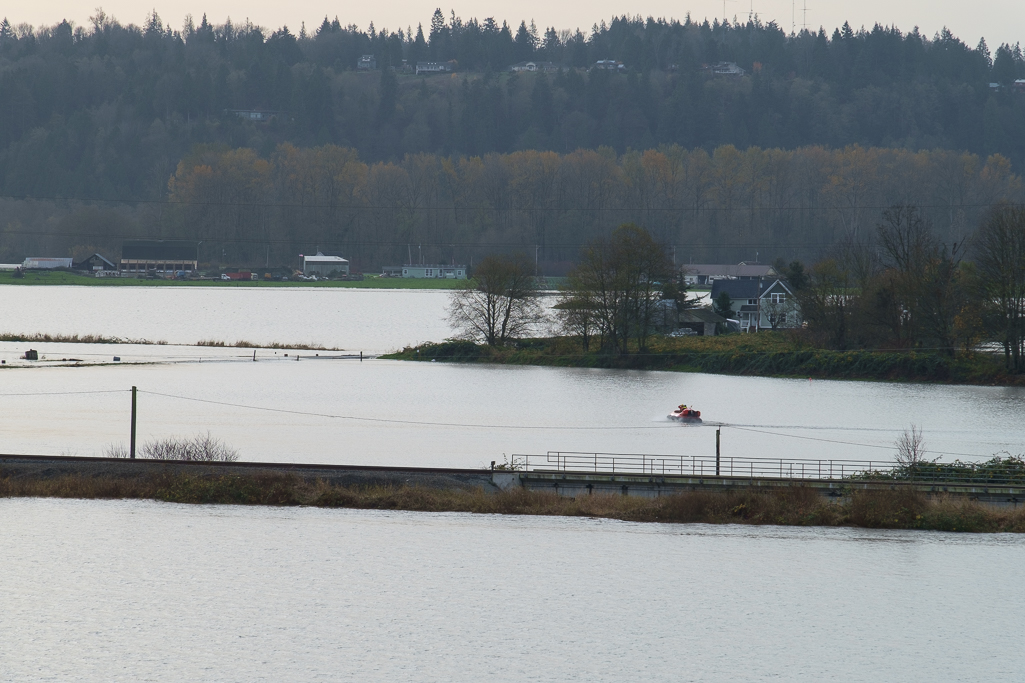  A rescue hovercraft crosses flooded farm fields and roads to check on residents stranded during the flood. 