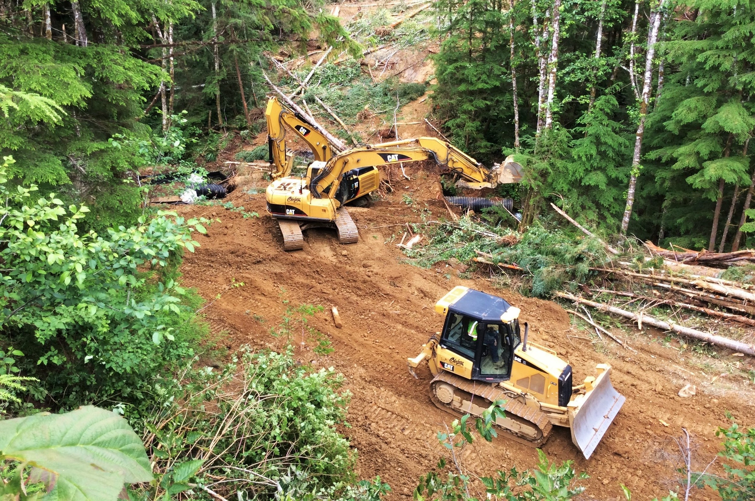  Two excavators, a bulldozer, and an off-road haul truck (not pictured) were used to do the work. 