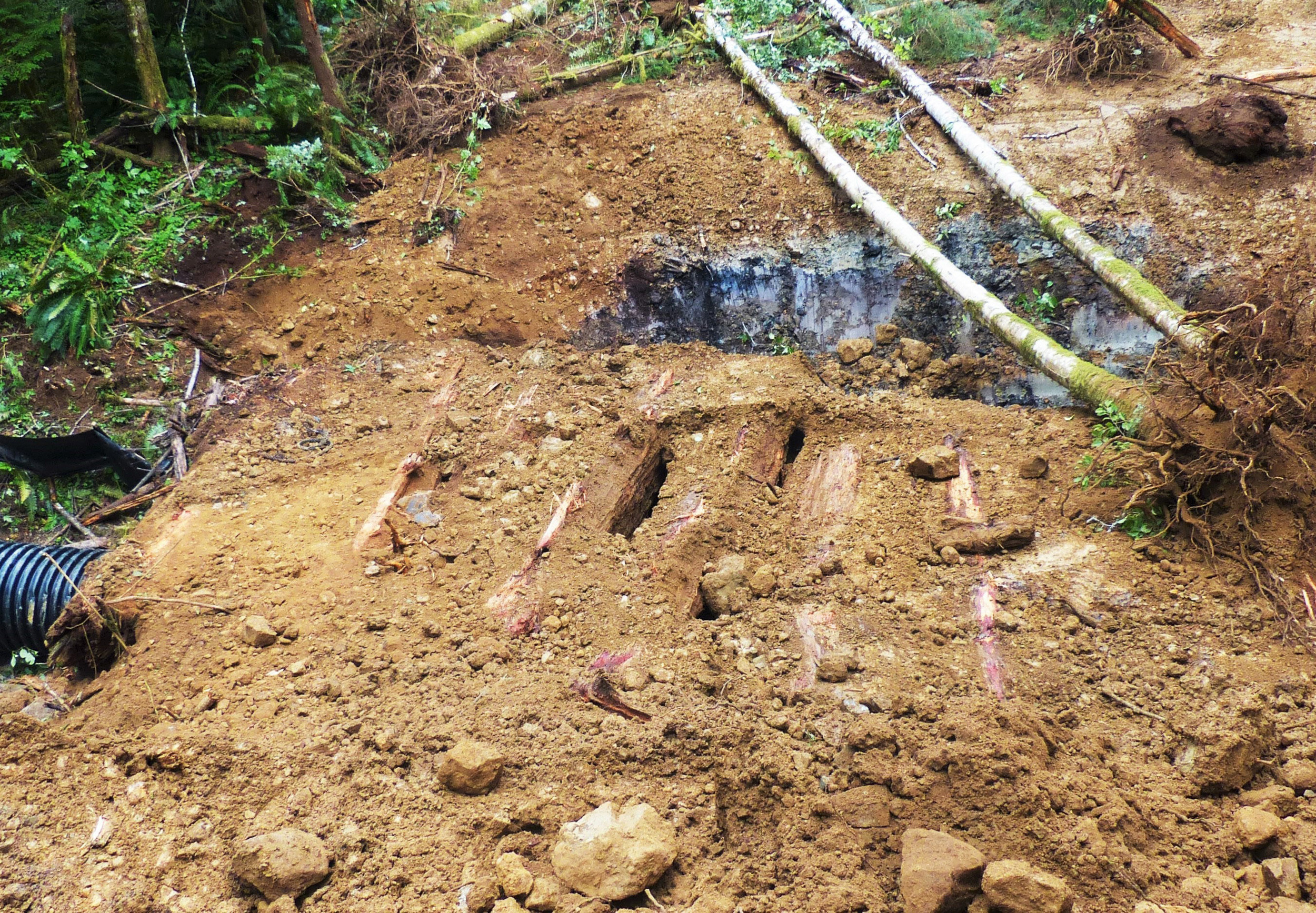  After uncovering several feet of earth, the bridge decking is revealed.&nbsp; 