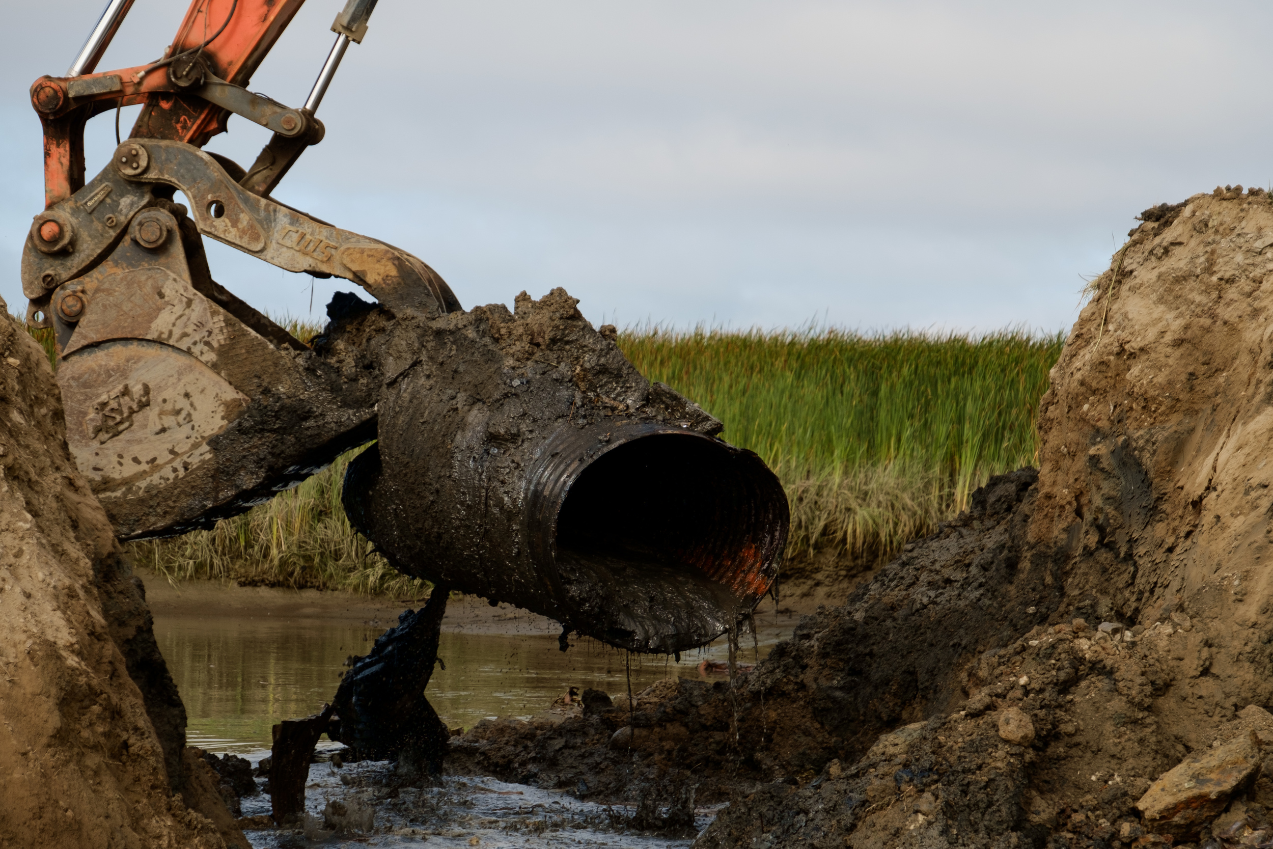  Old tidegate infrastructure is removed from the dike at the breach site. &nbsp; 