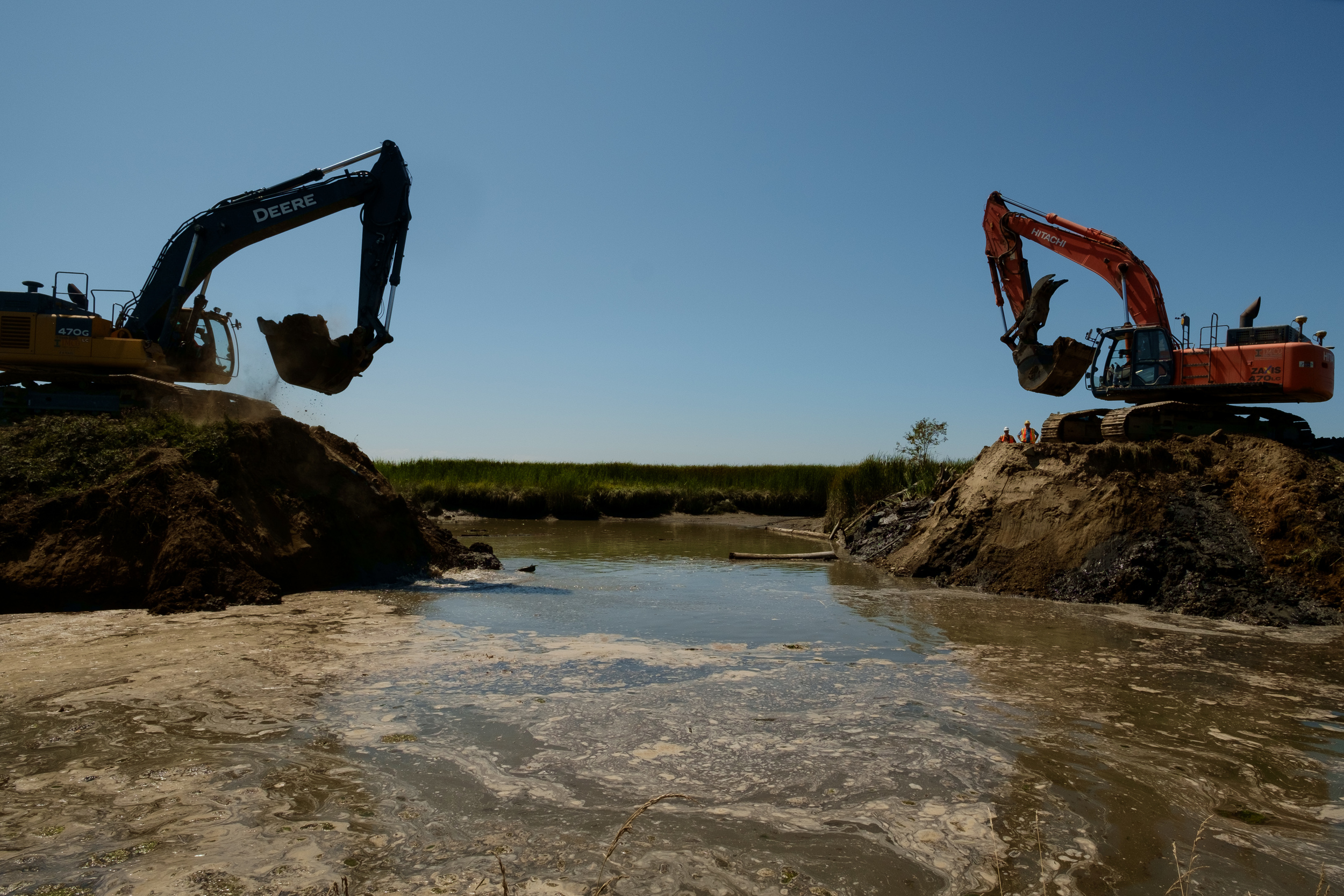  Excavators continue to work widening the breach site as the tide flows in.&nbsp; 