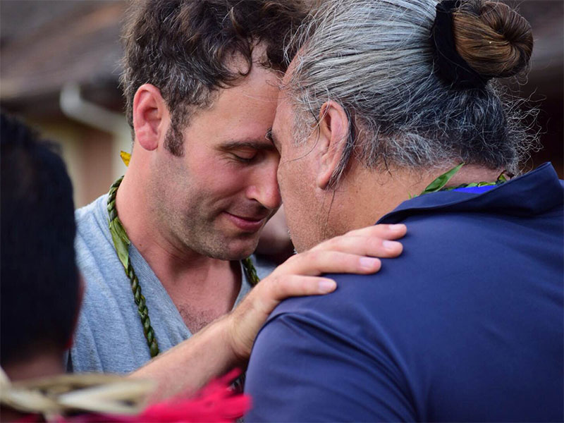 TNC Canada's Michael Reid greets another participant in the traditional Hawaiian way, touching foreheads and sharing a breath. 