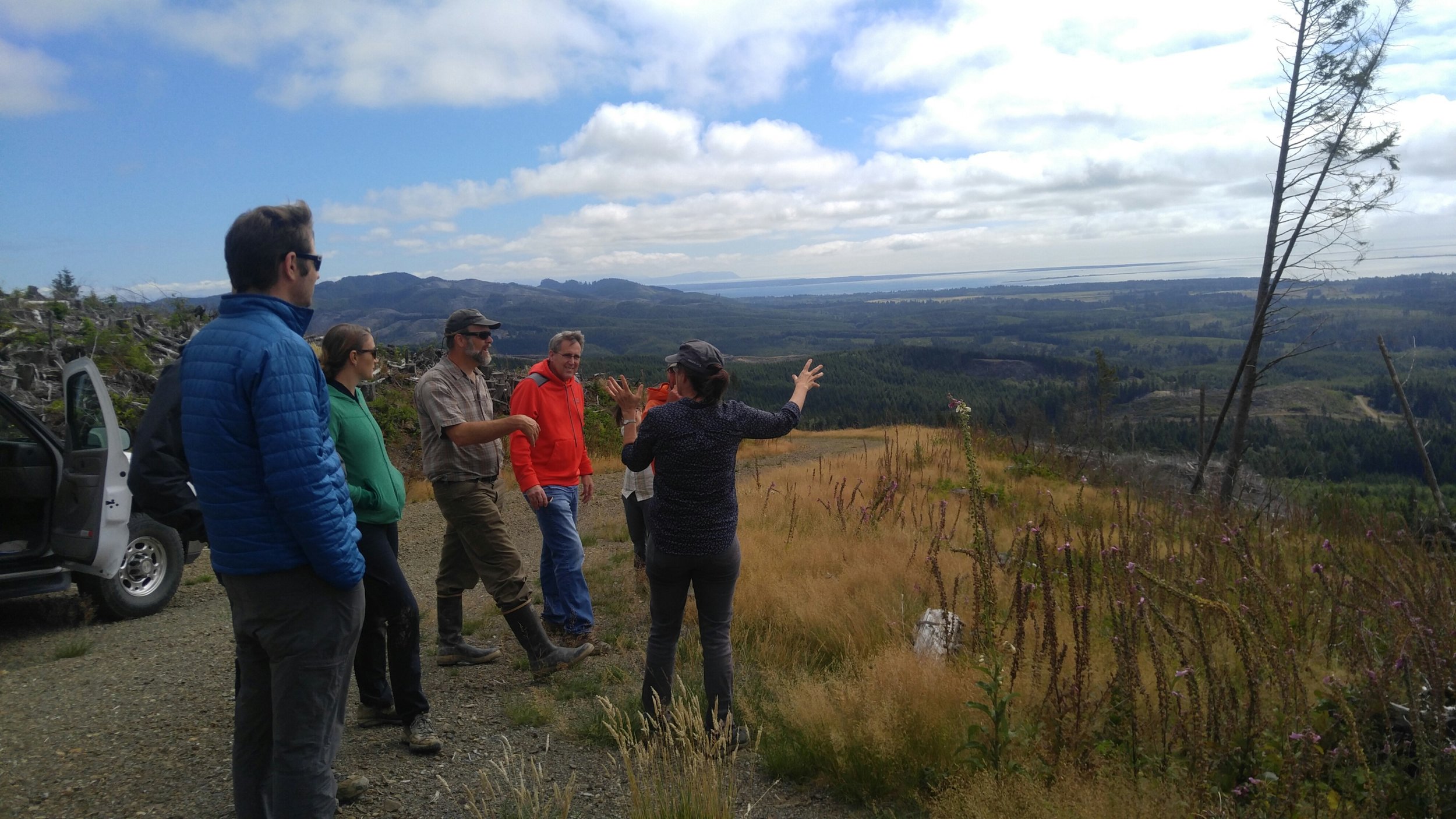  TNC’s Federal Government Relations Director Cathy Baker and Tom Kollasch from Pacific County Conservation District talk with the group while overlooking the cooperatively managed lands and the Columbia River delta. Photo ©&nbsp;Jessica Helsley 