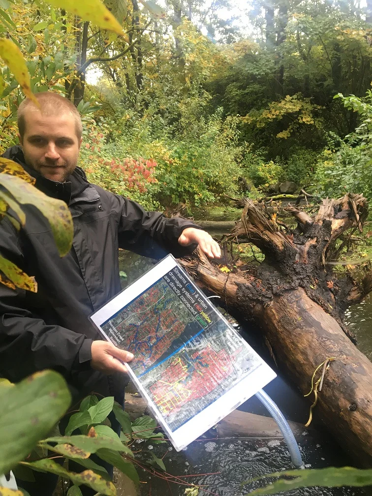 Skuyler Herzog looking at log jam in Thornton Creek. © Camilo McConnell