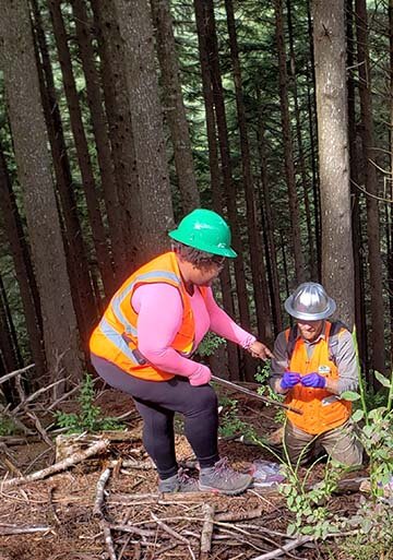 Dr. Tiara Moore (left), postdoctoral research associate, and Dr. Michael Case, forest ecologist, collect environmental DNA samples at Ellsworth Creek in SW Washington. Photo by Robin Stanton.