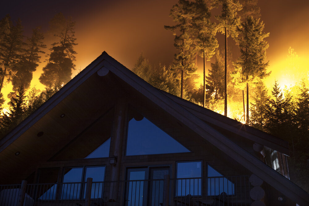 A fire burns near a home in Central Washington. © John Marshall