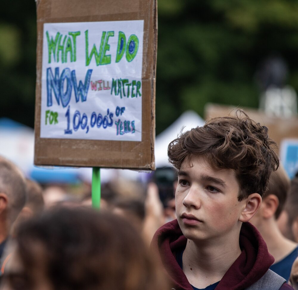 A young activist reminds us what’s at stake. Seattle Climate Strike, September 20, 2019. Photo by Djordje Zlatanovic.