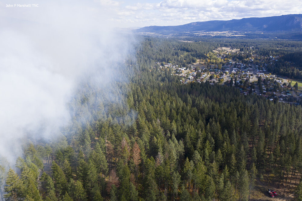Smoke rises from a 6-acre prescribed fire in the Roslyn Urban Forest on Oct. 6, 2021. The town of Roslyn is seen in the background. Photo © John Marshall