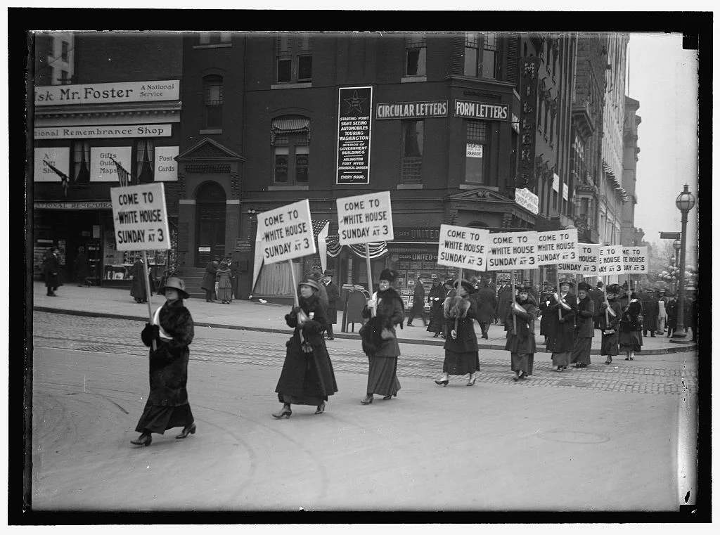WOMAN SUFFRAGE. MARCHING WITH INV. SIGNS