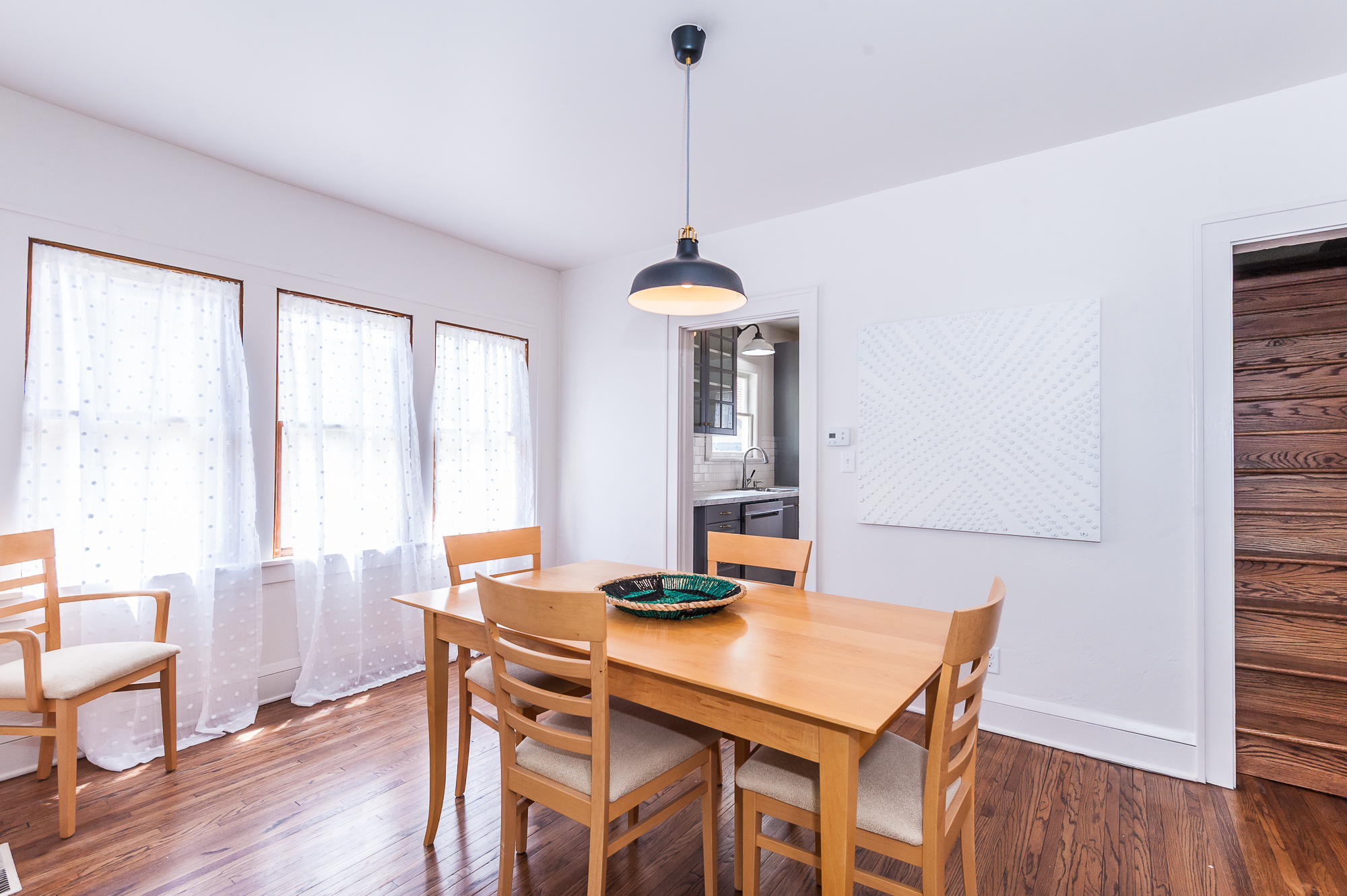 Main floor: Dining area boasts lots of light and seating for four.