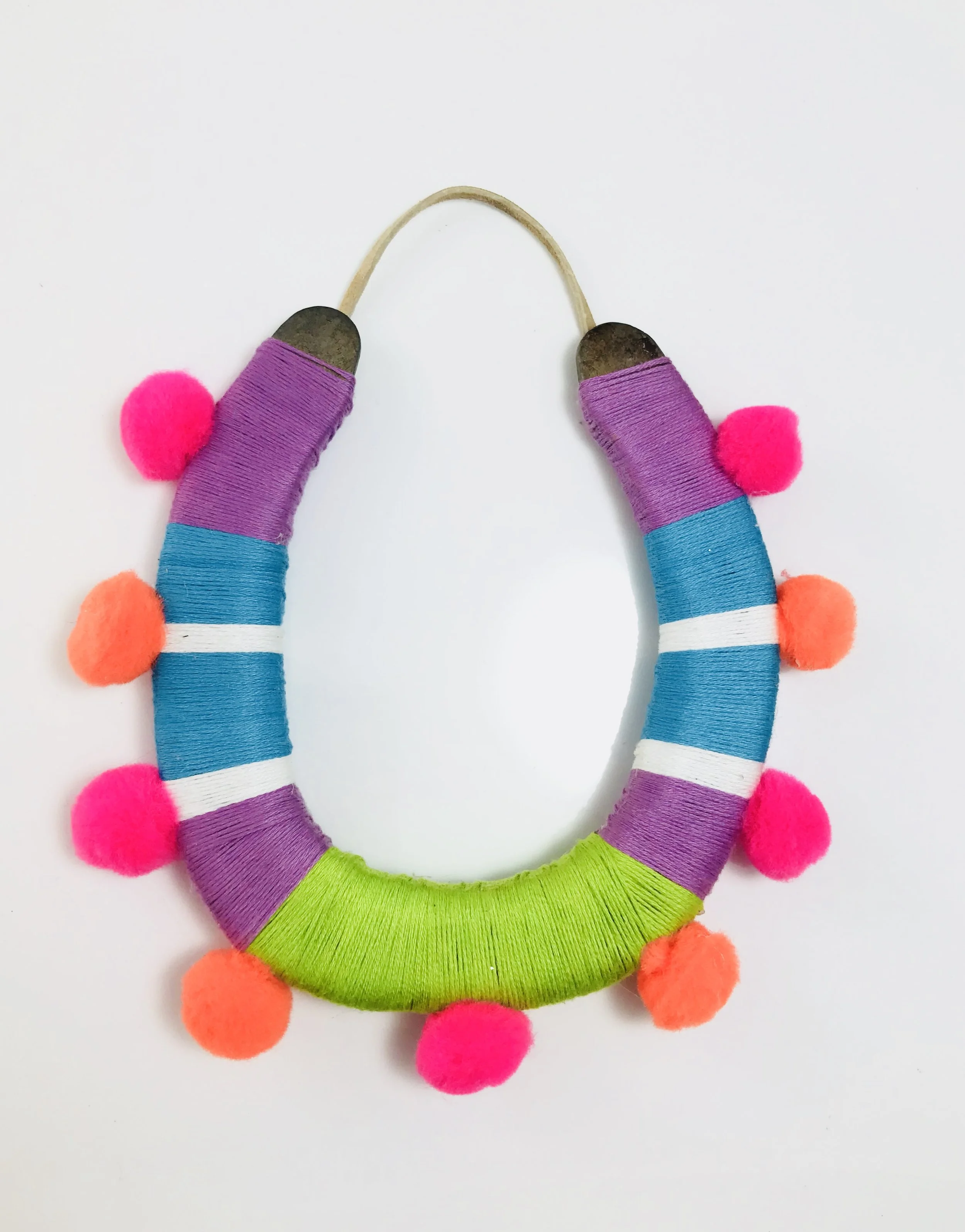 Lucky horseshoe with pompoms in green