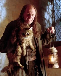 Argus Filch (David Bradley) and Mrs. Norris (Pebbles) in the Harry Potter series.