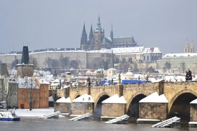 The Charles Bridge over the Vltava River, the Prague Castle and St. Vitus Cathedral above.