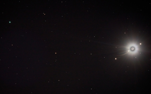 Blue-green Uranus (upper left) appears close to Jupiter (lower right) and her four Galilean moons, even though they are approximately 1.3 billion miles apart—a deception of the telescope. © NASA
