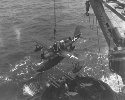 Kingfisher spotter plane is hoisted back onto deck on the USS Texas.