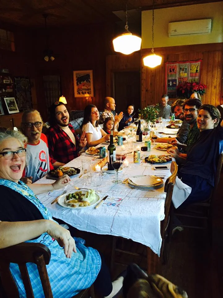 13 of 14 seated at the thanksgiving table. 