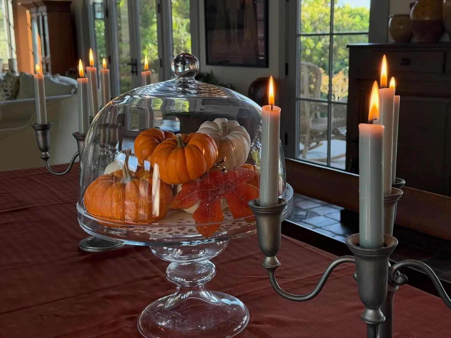 A #simple #autumn #tablescape using #pumpkins under a dome or #cloche, a glitter #leaf, and #romantic #sage taper #candles to set the mood.

#fallcolors #falldecor #tablescapedesign #frenchcountryliving #domainedemanon