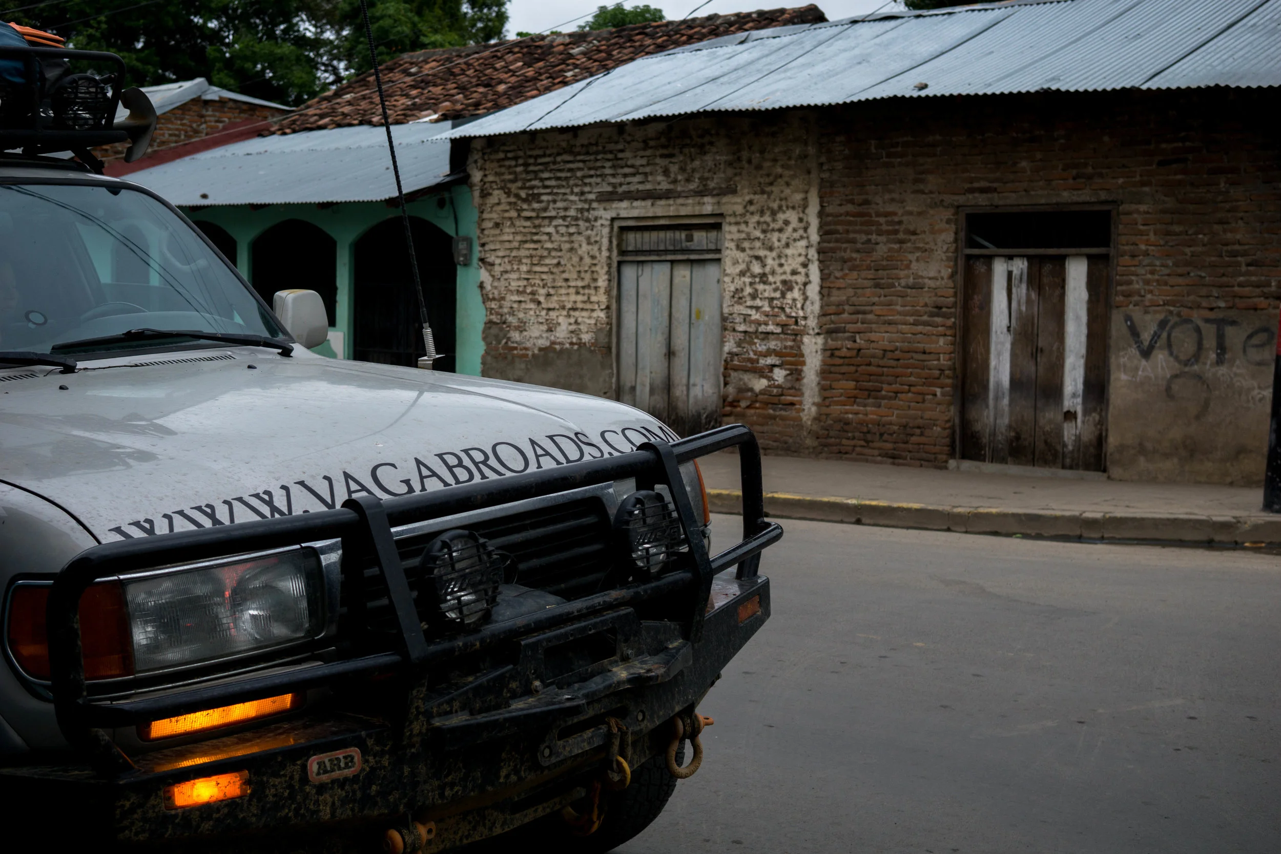 car in granada street in front of brick home.jpg