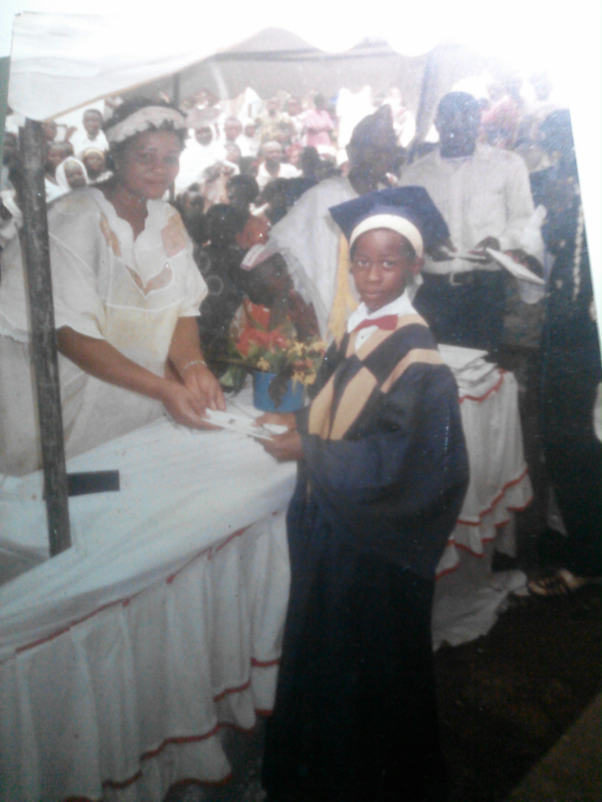 Obioma, age 11 or 12, receiving the award for best literature student at his primary school in 1998.