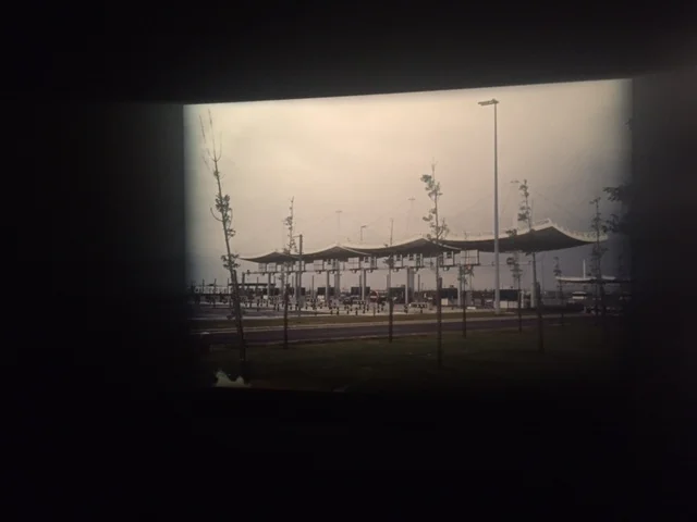 A photograph of a tollbooth hung on a darkly painted wall, the bleak representation of suburban France at "Michel Houellebecq: French Bashing." The author's first art show in the US opened on Friday in New York.