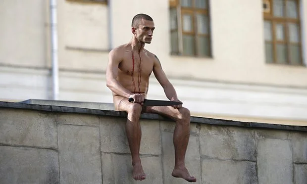 Pavlensky during a Pain Performance stunt called 'Segregation,' which was aimed at the psychiatric treatment forced upon Russian 'dissidents.' &nbsp;The photo was taken shortly after the artist severed his own earlobe. &nbsp;Photo credit:&nbsp;Maxim…
