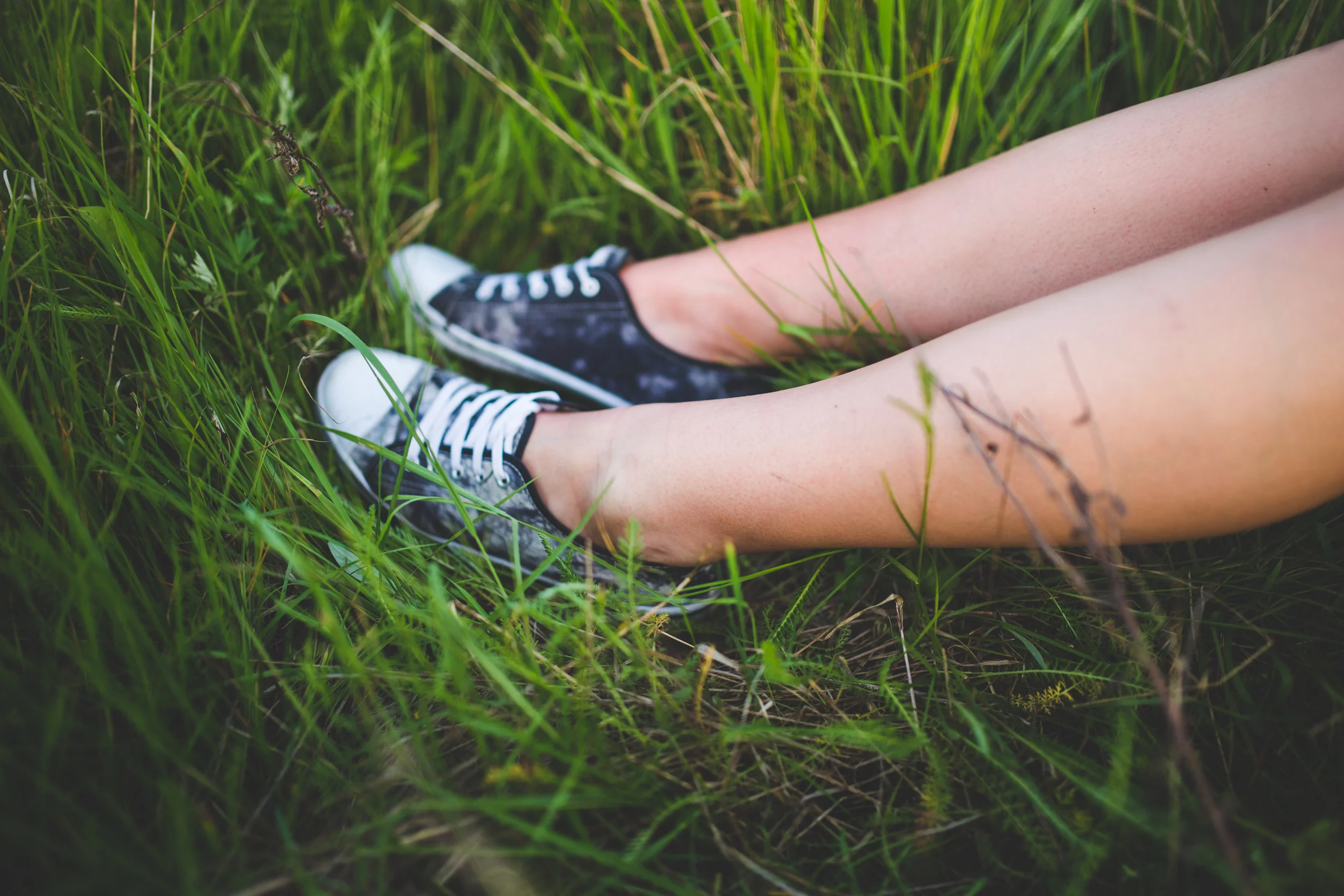 Teen's sneakers in the grass