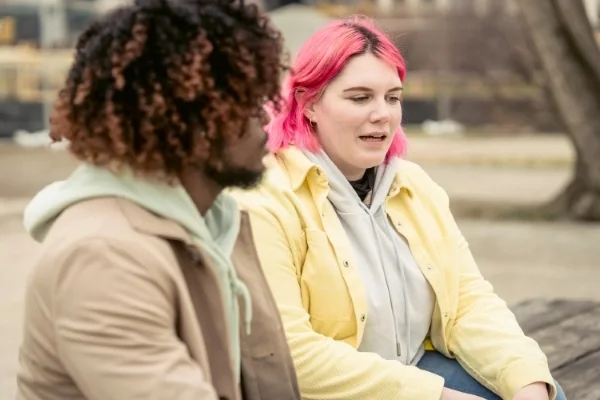 Two people talking in a park