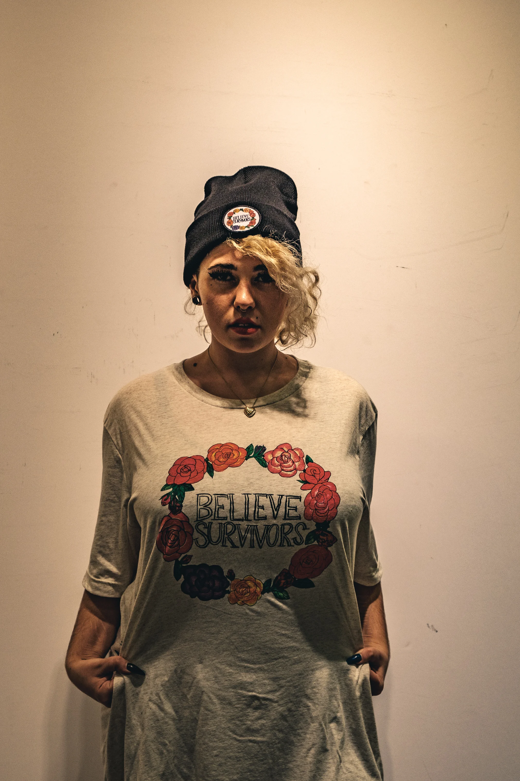 black unisex beanie with embroidered patch ring of flowers "believe survivors" text - dfrntpigeon