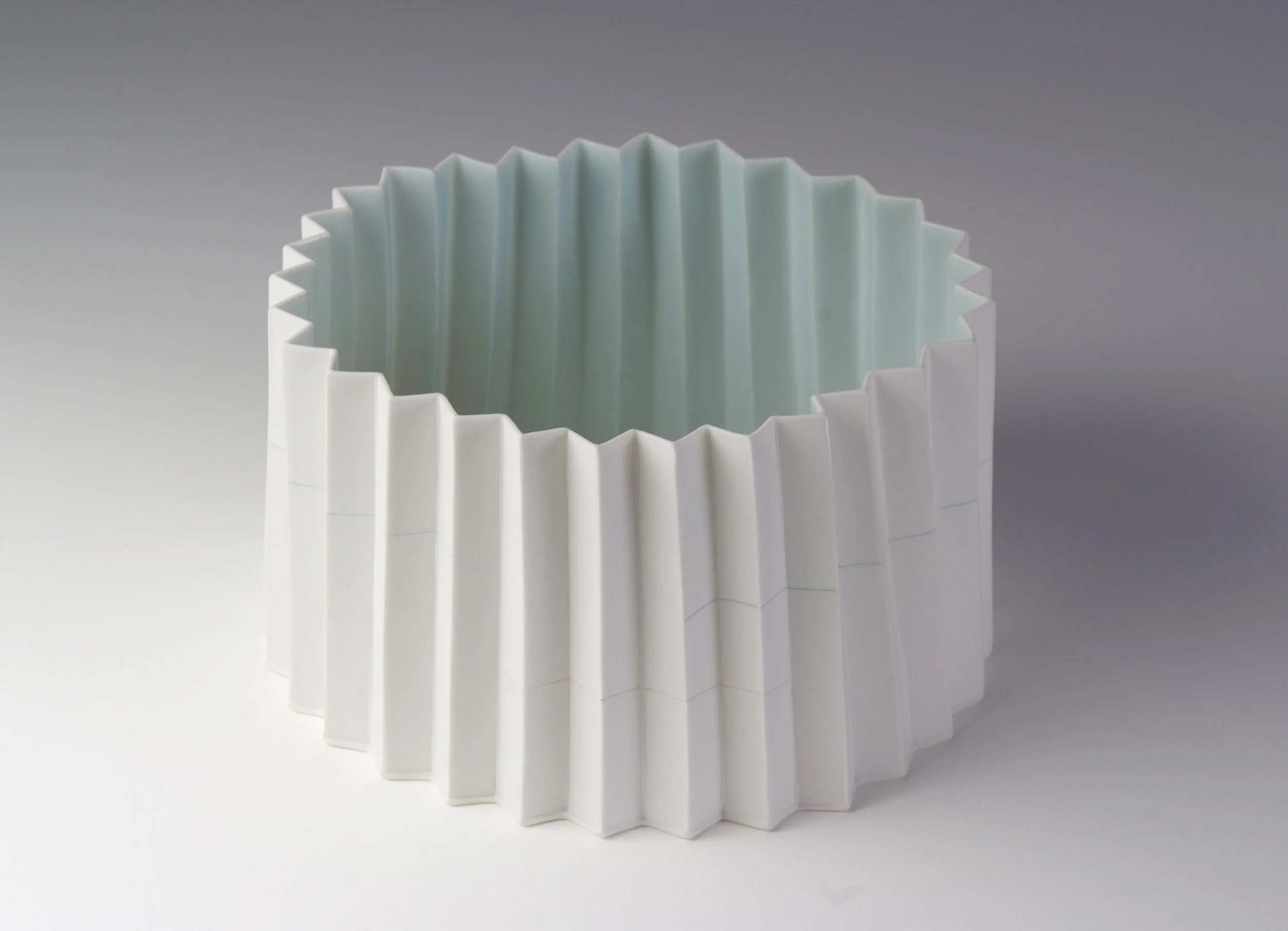 Kenji Uranishi, Pleated bowl 2009, porcelain with inlaid slip and celadon glaze, 11.8 x 20.0cm, Les Renfrew Bequest 2009, Newcastle Art Gallery collection