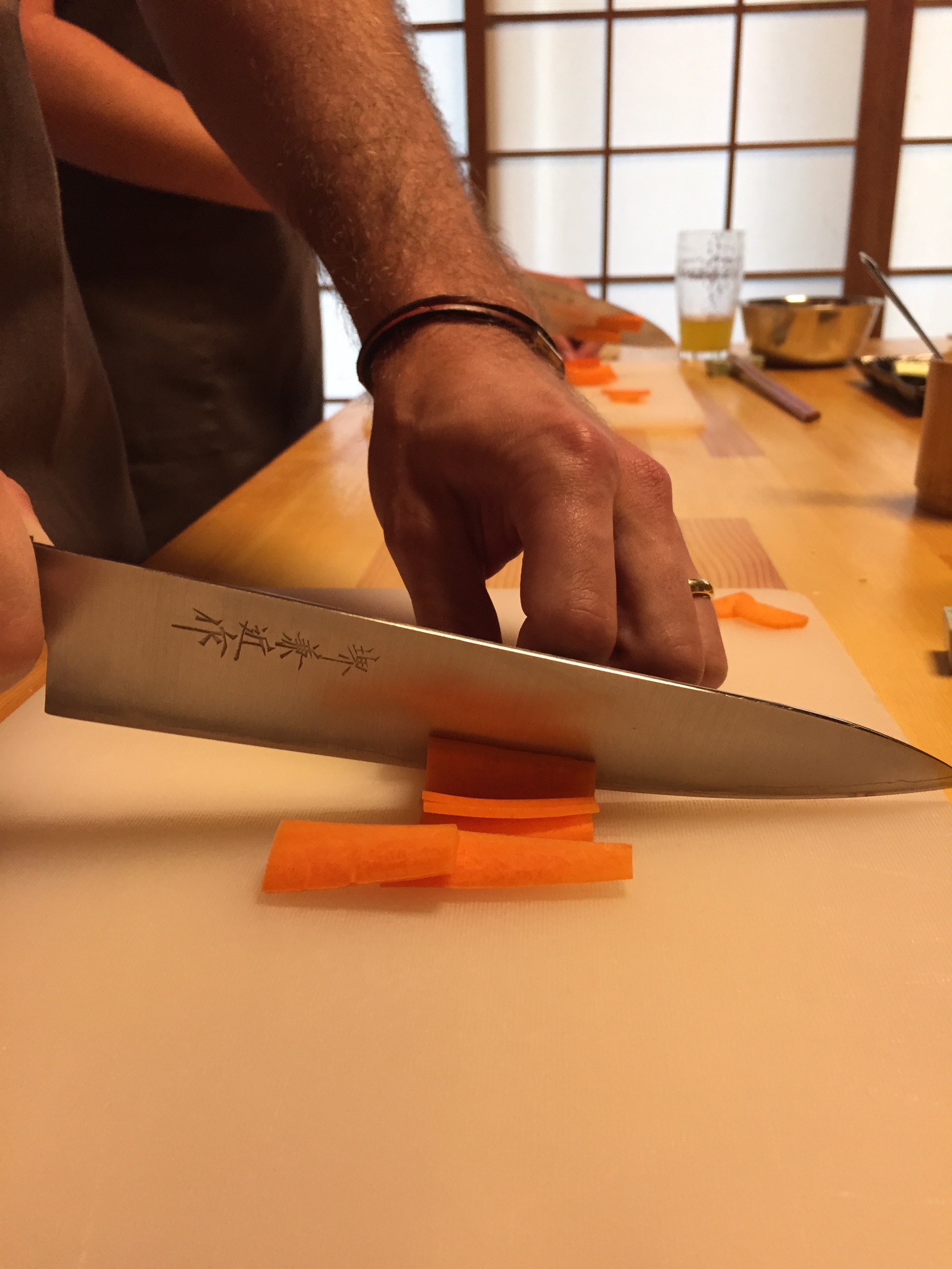 Cole chops carrots at our Osaka Eats cooking class