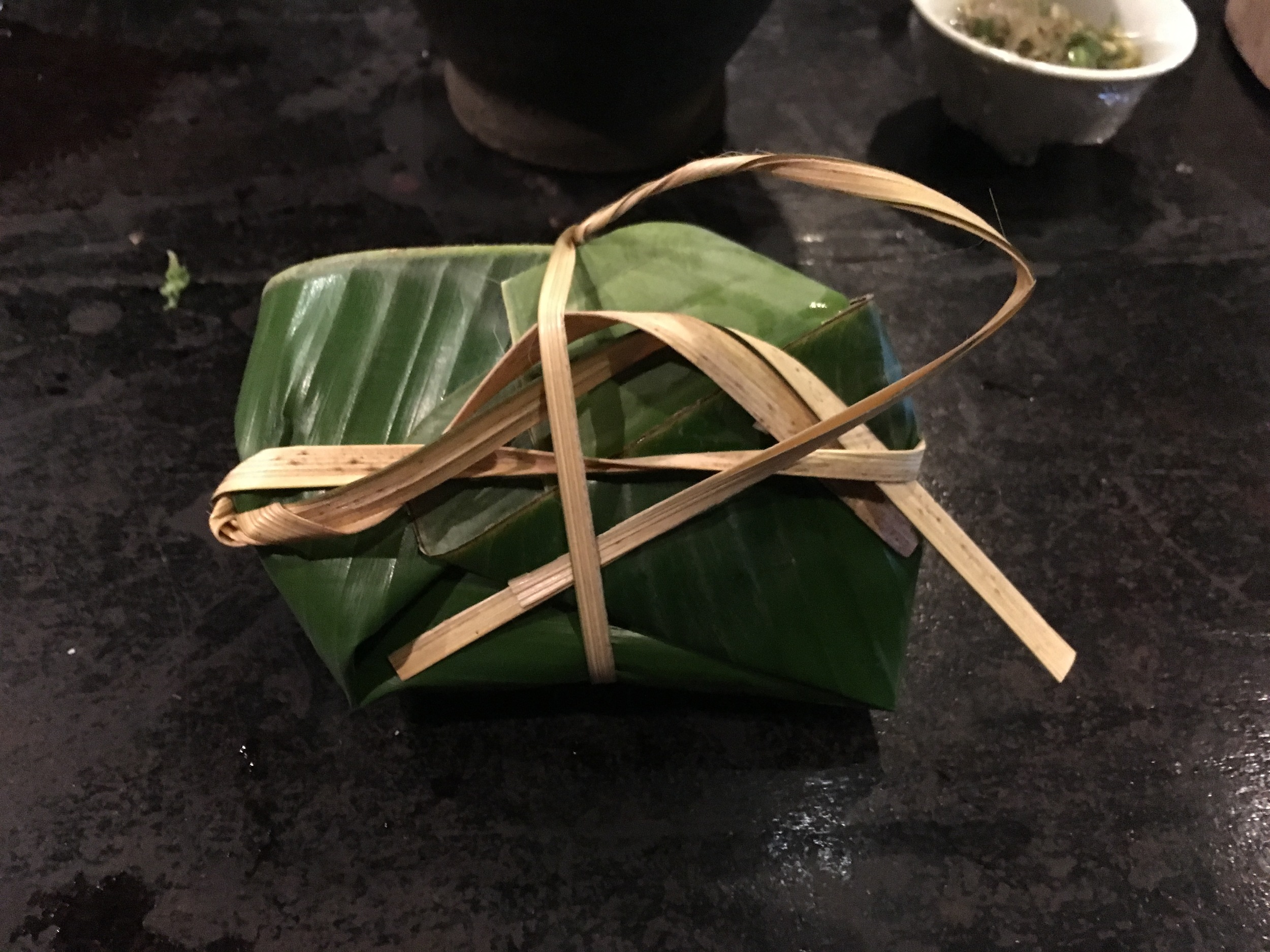 Tilapia wrapped in banana leaf