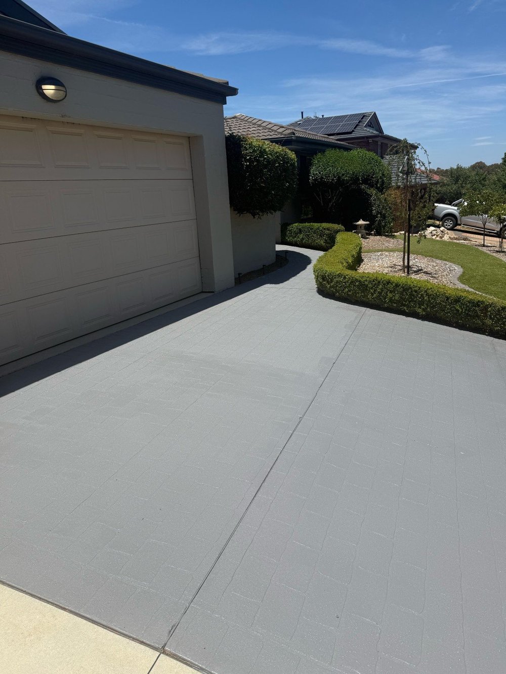 Same driveway after cleaning and resealing in a new grey colour in Canberra
