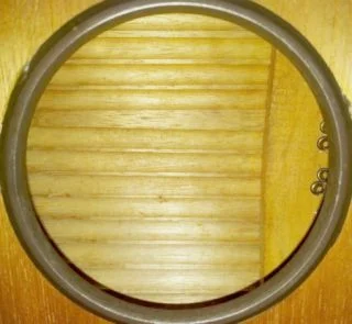 Sound grooves in underside of 1980's Taiwanese guzheng, taken through sound hole. Photograph by author.