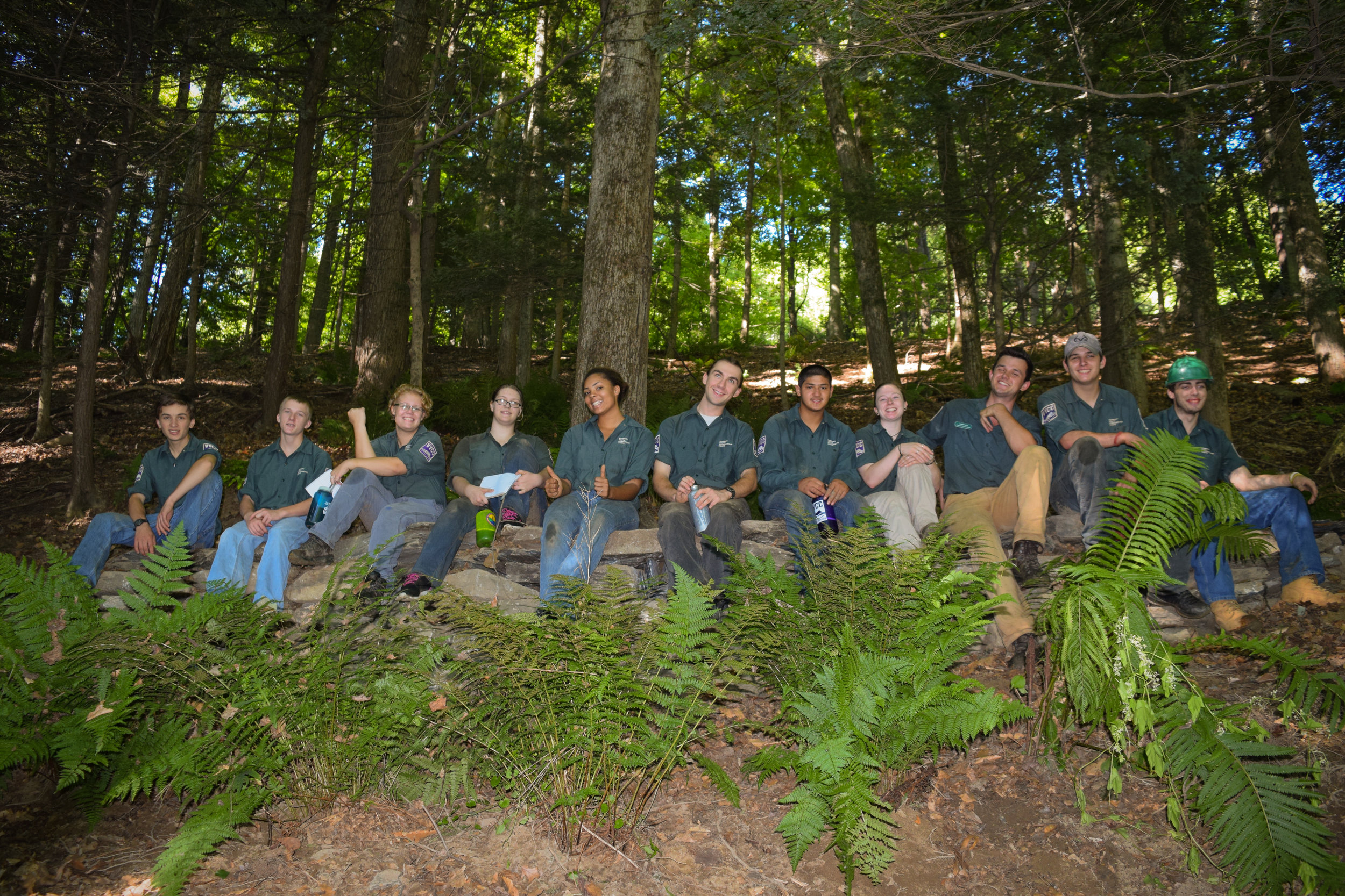 The crew atop the 48-square-foot stone retaining wall they built