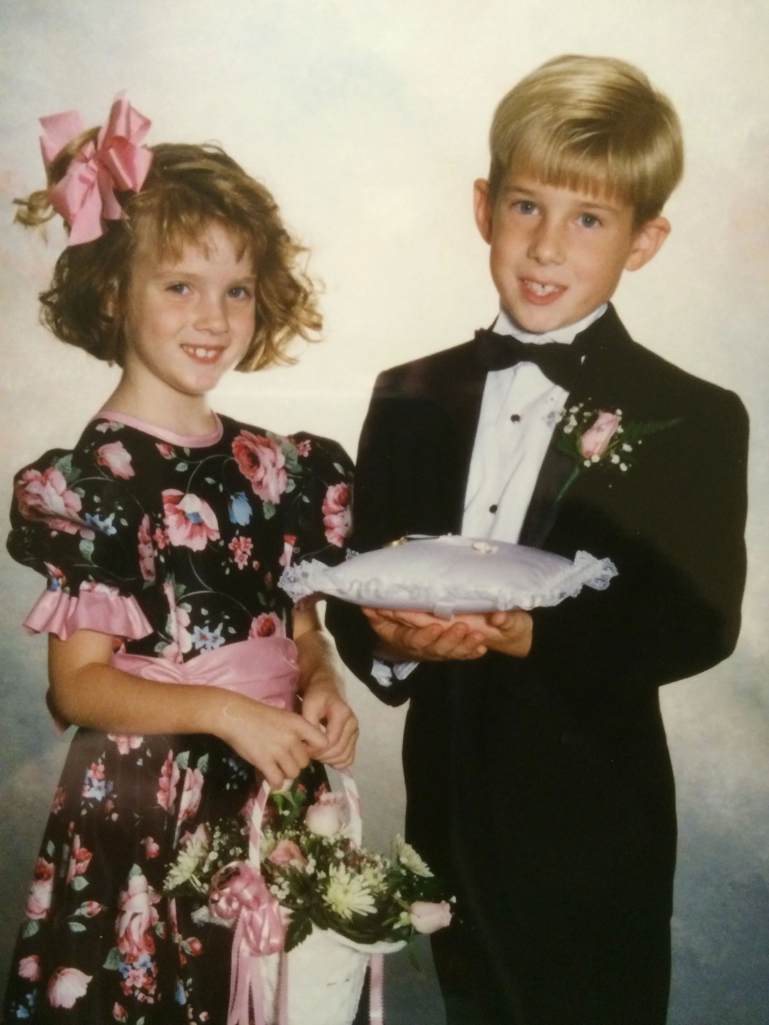 My cousin, Adam, and I as the ring bearer and flower girl in our aunt's wedding. Circa 1992
