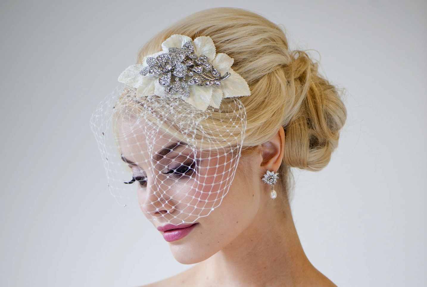 This beautiful birdcage veil adds a romantic feel to her ensemble.