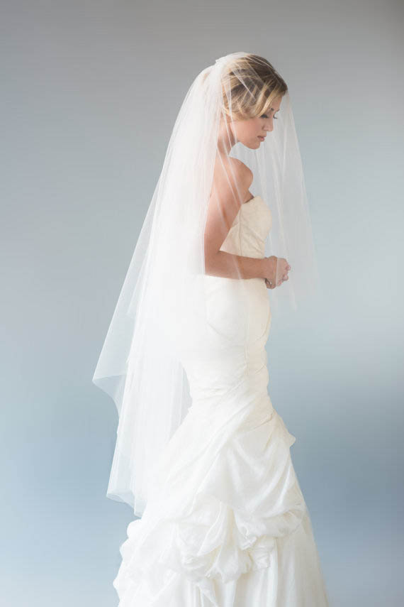 This waltz length veil is long but doesn't quite touch the floor. 