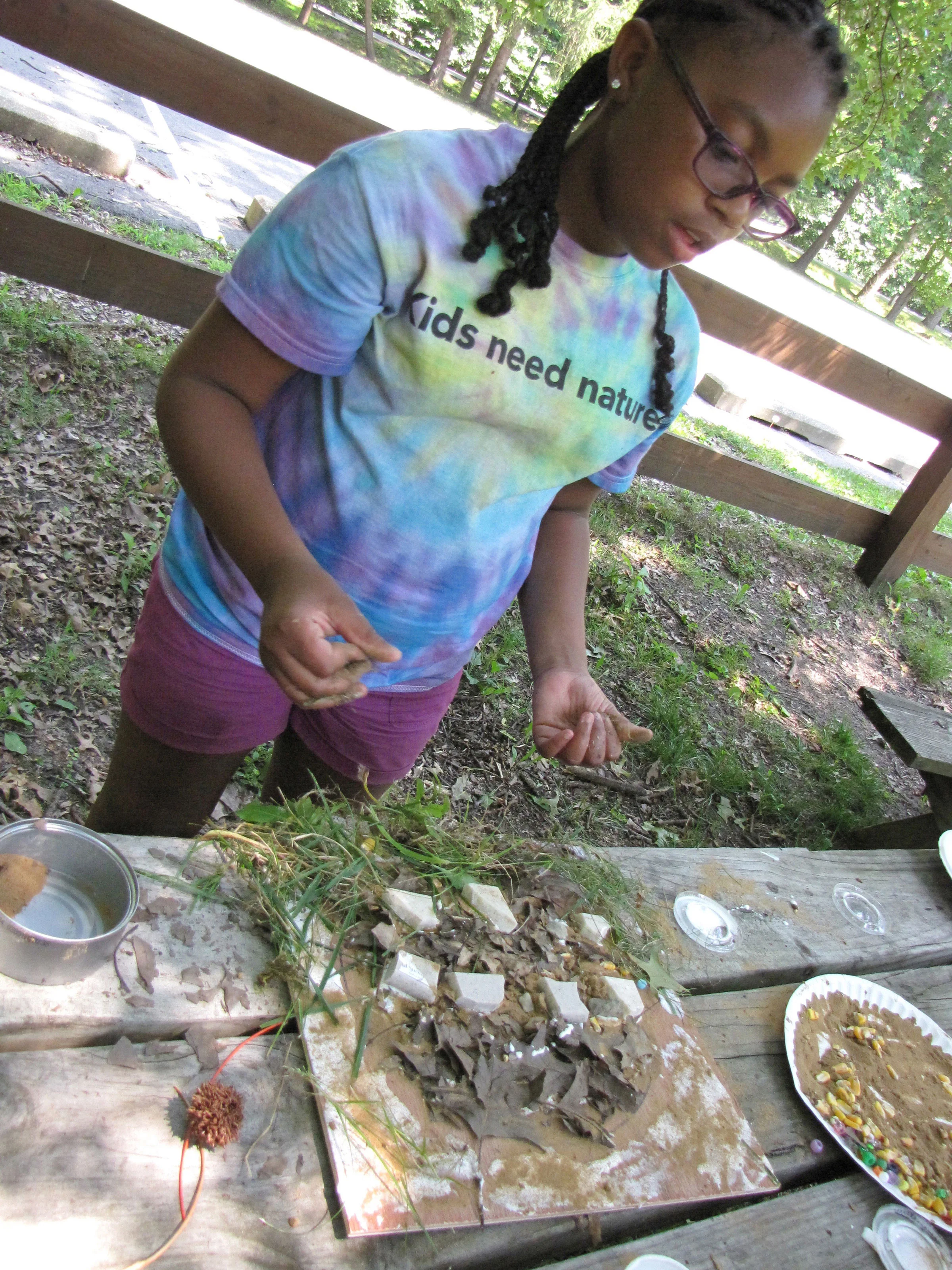 A camper explains the ecosystems represented in her composition.