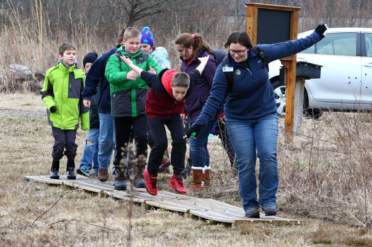 Ellie Althoff, Dunes LEarning Center outreach educator, in early march leads fifth graders from joan martin elementary school in hobart through the gordon & Faith greiner nature preserve Kale wilk, the times