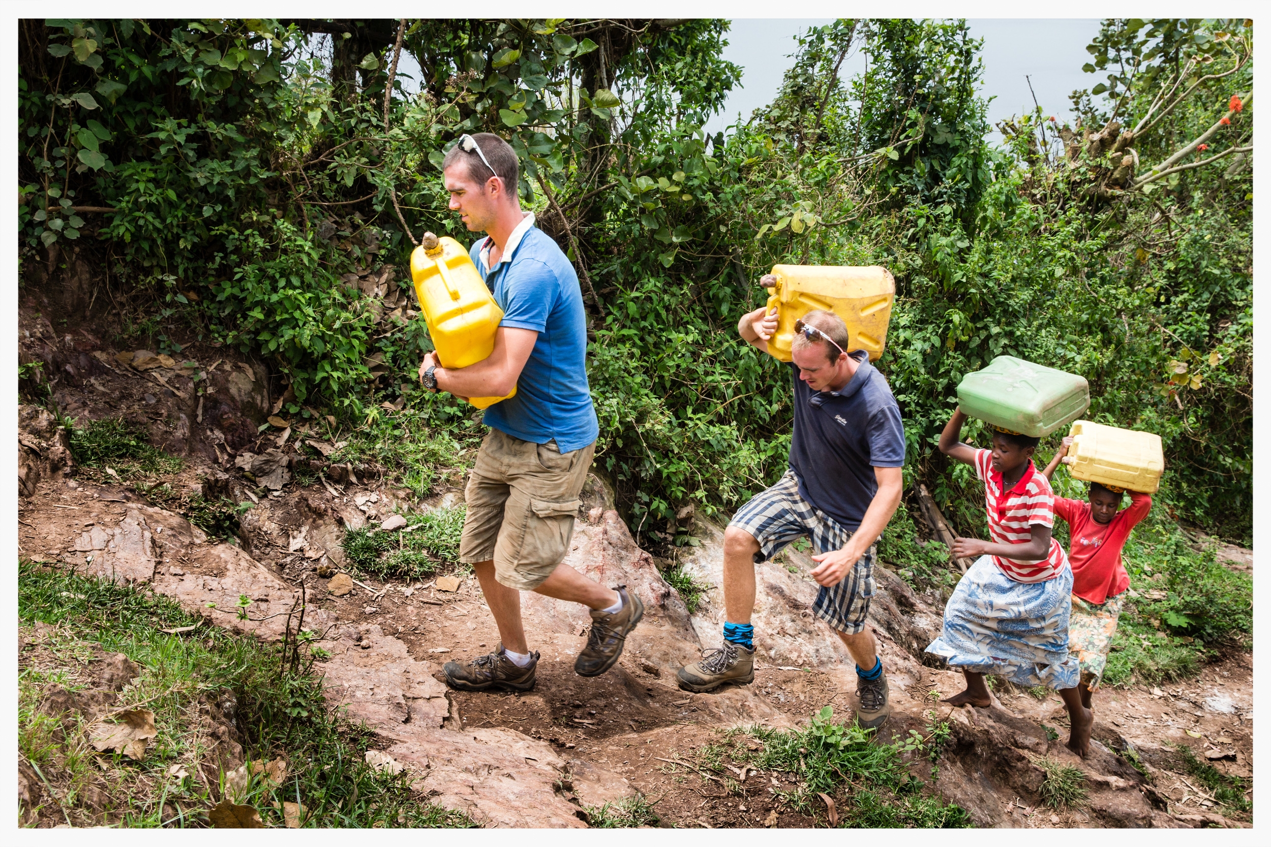 Richard and Peter Chambers join Doreen and Jouvllet on their daily trek to collect water. Despite the athletes' fitness, they admitted the walk had been far tougher than expected. Kabale district, southwest Uganda. Photo © Marcus Perkins